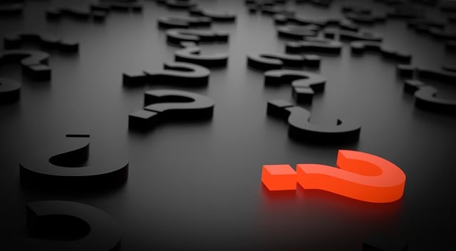 a red question mark in a sea of black question marks