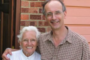 A man and a woman standing next to each other in a hug