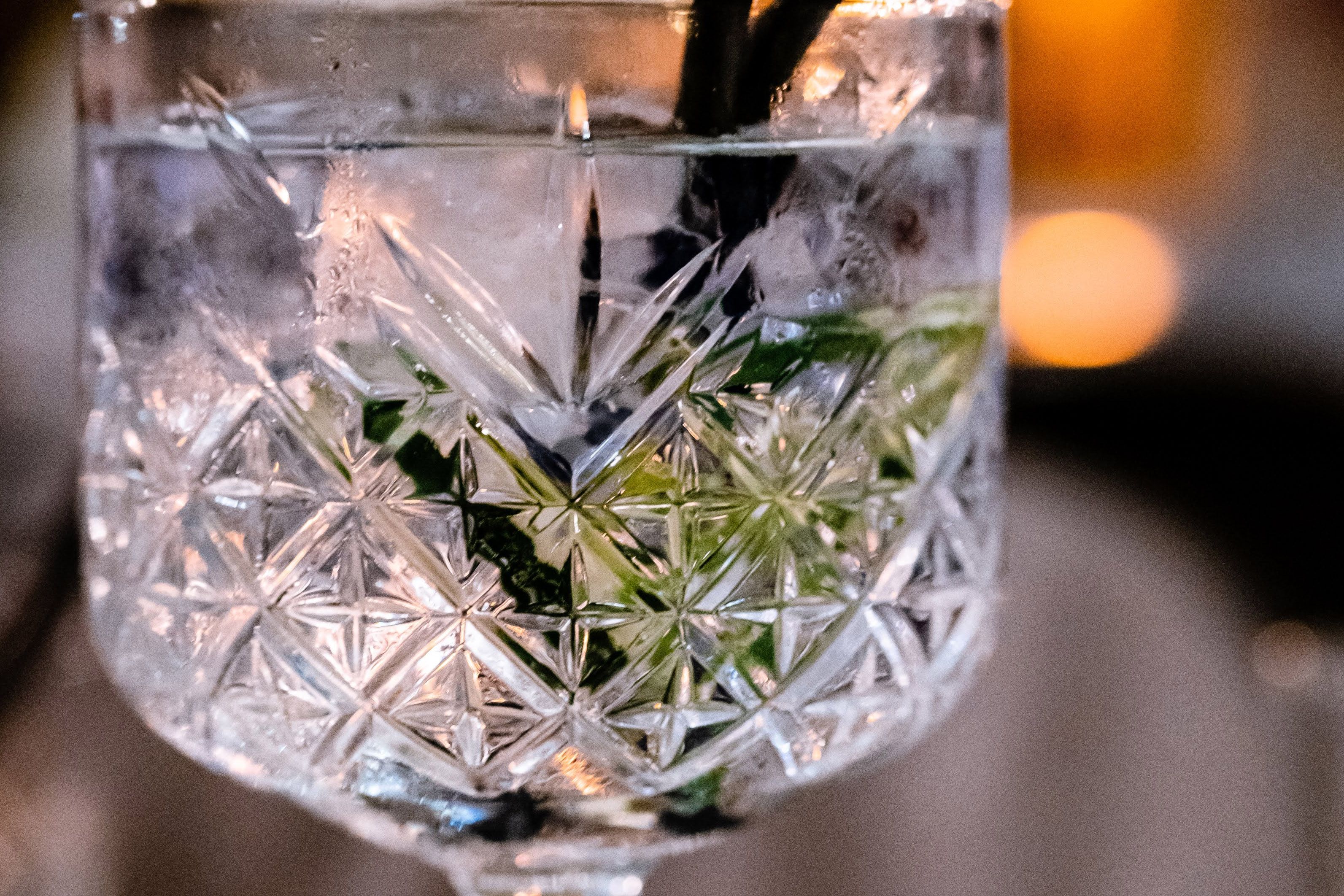 a crystal goblet with a clear drink in