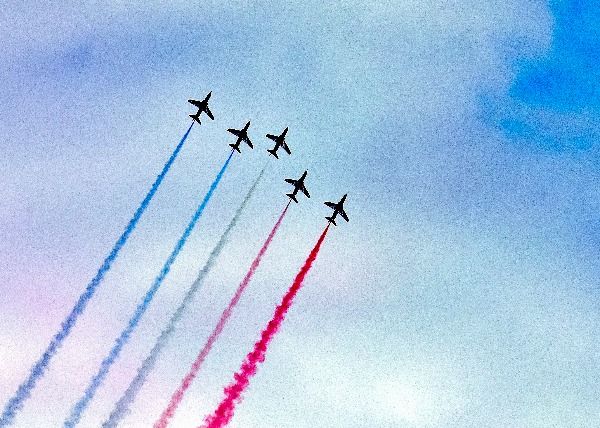planes in the sky with red white and blue trails