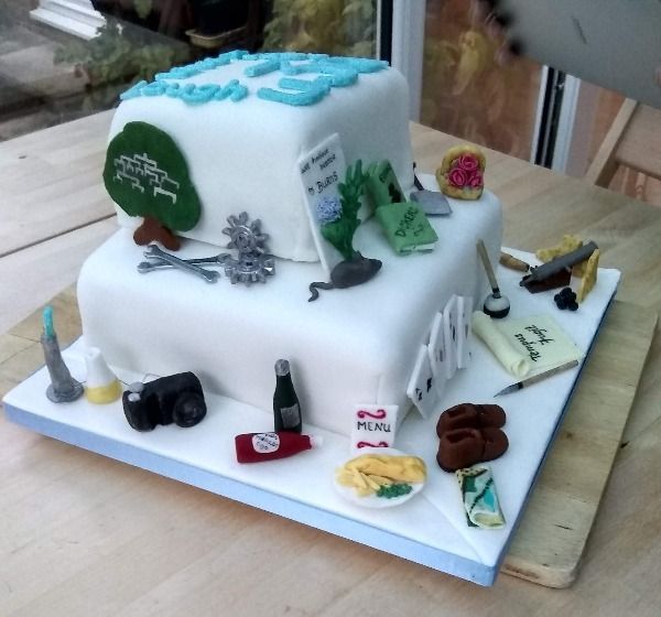 side view of a two tier u3a activities decorated cake 