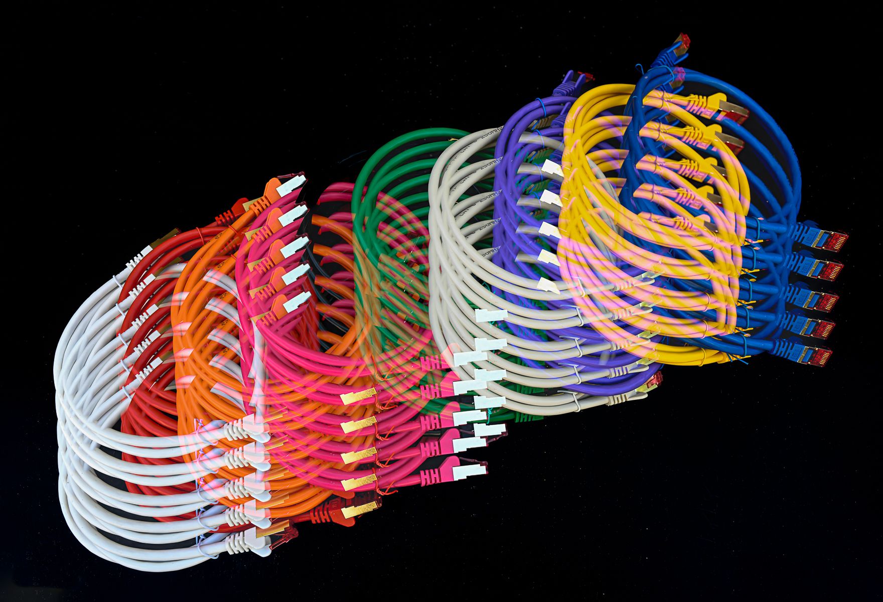 An edited photo of coloured cables against a black background